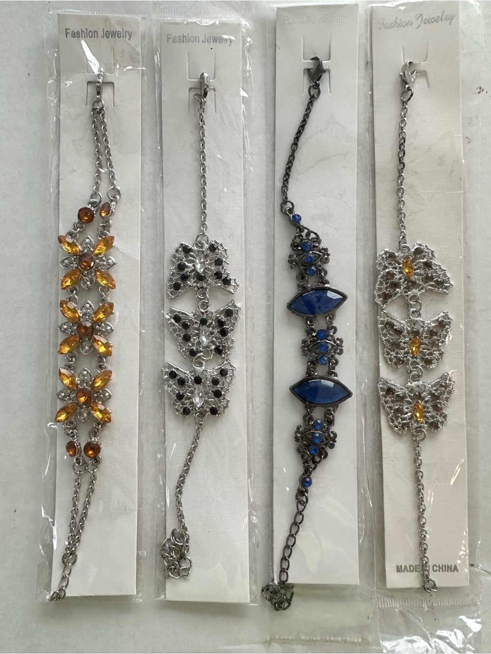 Set of 4 Women’s Silver tone Bracelet with colored Accents